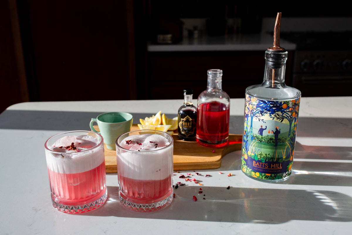 Batts Hill Cucumber and Clementine Gin Hibiscus Gin Sour with edible flower garnish
